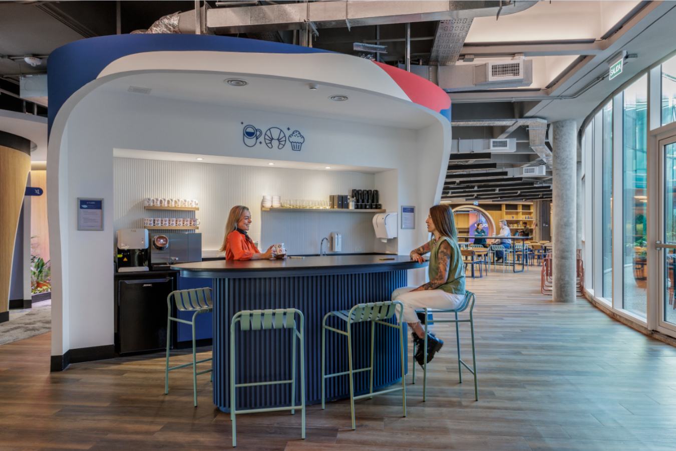 Uala Offices 2024 - Social coffee hub featuring branded blue cabinetry and bar seating - Contract Workplaces.jpg